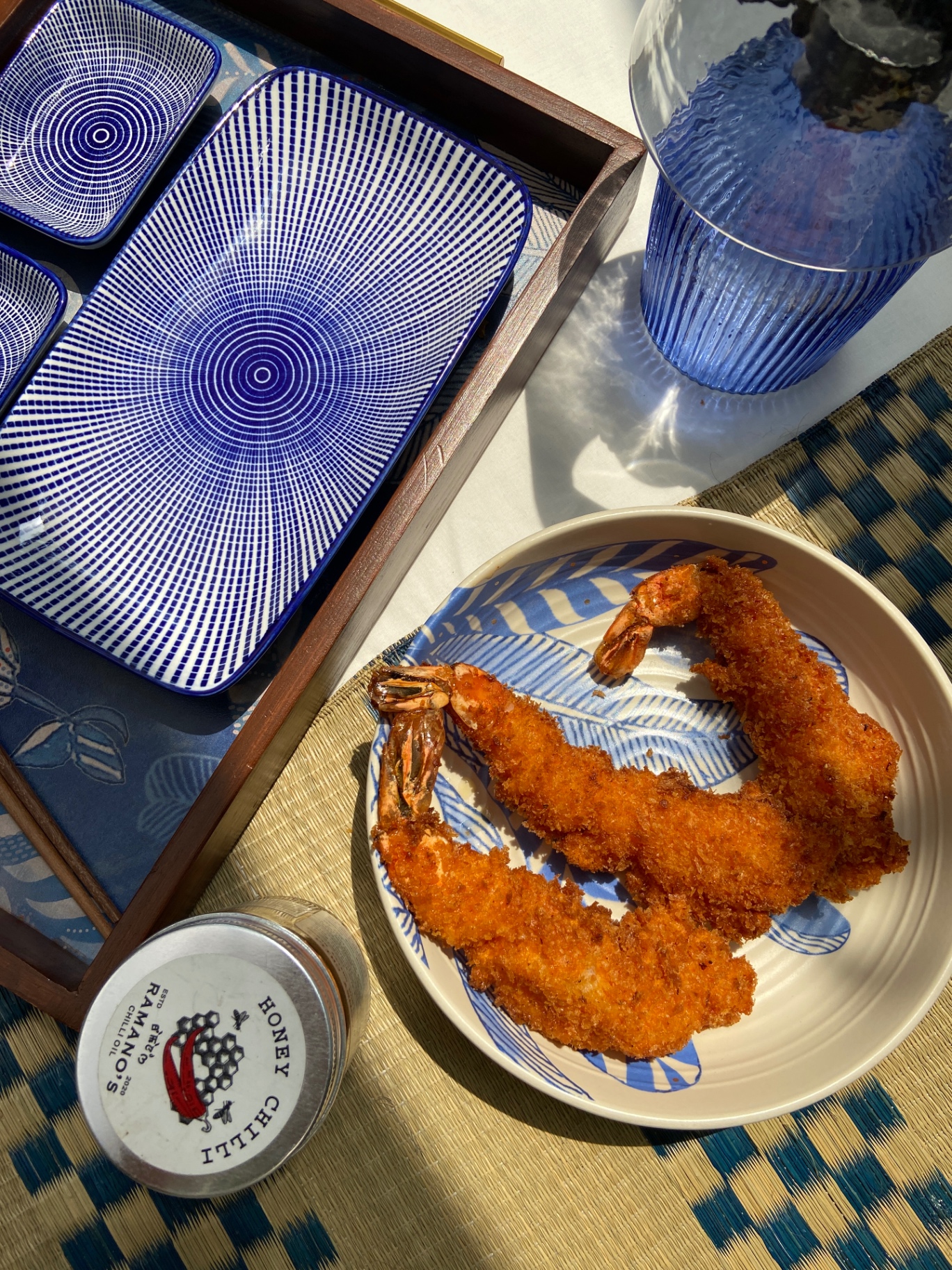 Crispy panko shrimp on indigo ceramics with Ramano's honey chilli oil